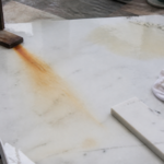 Diagnosing Rust Blooms in Carrara Marble: Iron Oxidation vs Moisture Trapping